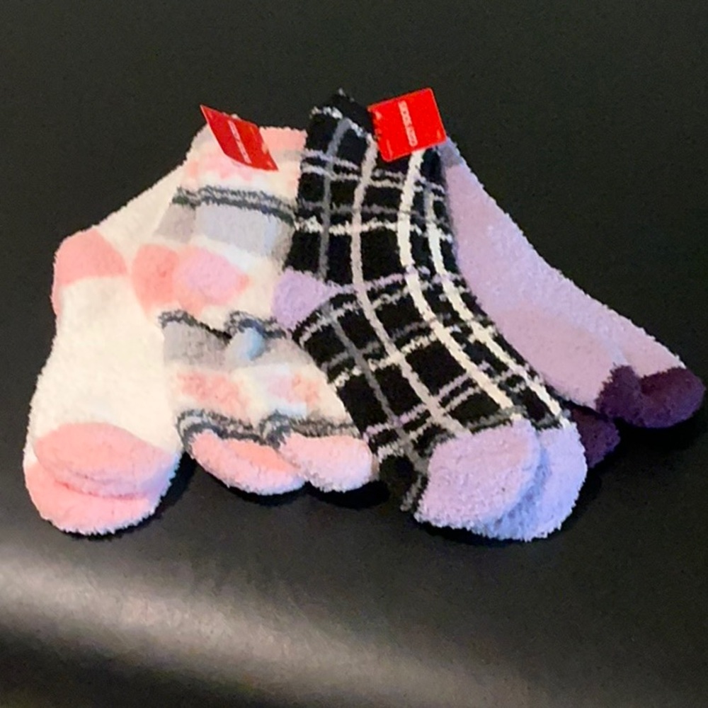Four pairs of cozy pink and purple socks